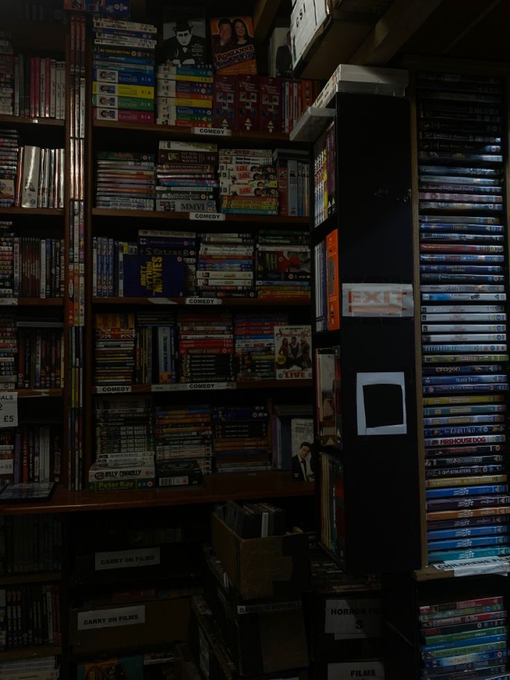 a room filled with lots of different types of dvd's and movies on shelves