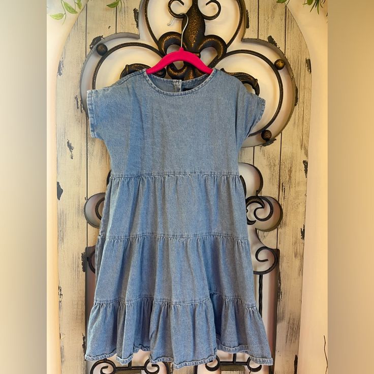 Kidpik Girls Denim Dress Back Functional Buttons Never Worn Smoke Free Pet Friendly Blue Washed Short Sleeve Dresses, Cute Short Sleeve Denim Dress, Light Blue Short Sleeve Cotton Denim Dress, Light Blue Cotton Denim Dress With Short Sleeves, Light Blue Short Sleeve Denim Dress, Casual Denim Blue Dresses With Ruffles, Light Wash Ruffled Cotton Dress, Blue Casual Denim Dress With Ruffles, Cute Medium Wash Denim Dress