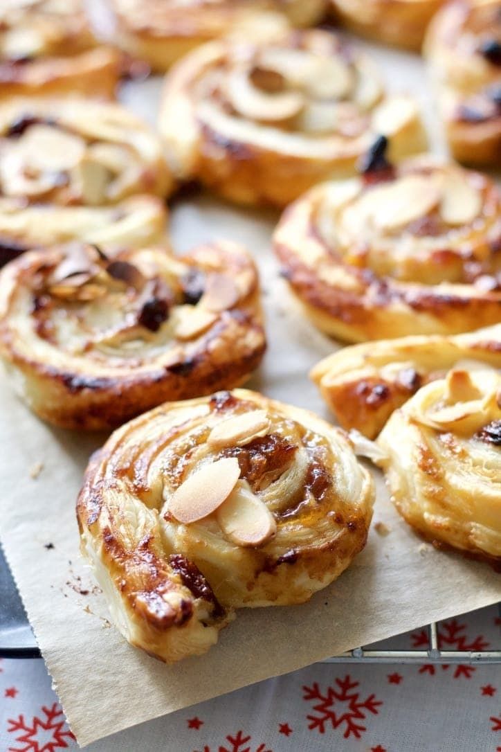 baked pastry items displayed on paper with red and white snowflakes in the background