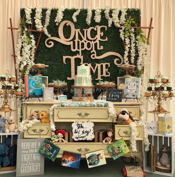 an old dresser is decorated with flowers and books for a children's birthday party