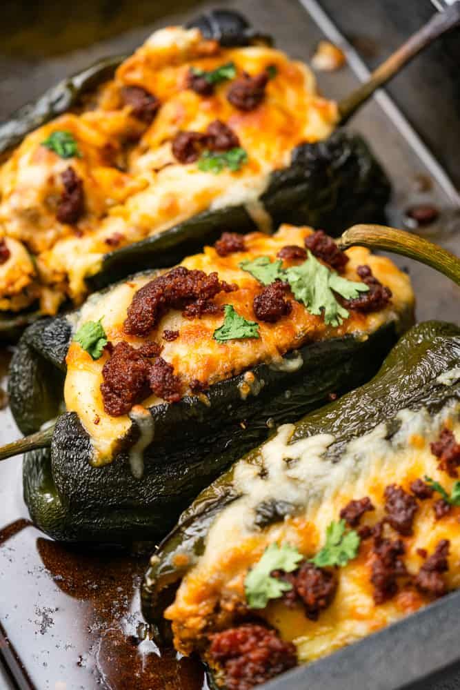 stuffed poblano peppers with chorizo are on a baking sheet and the title reads, keto stuffed poblano peppers with chorizo