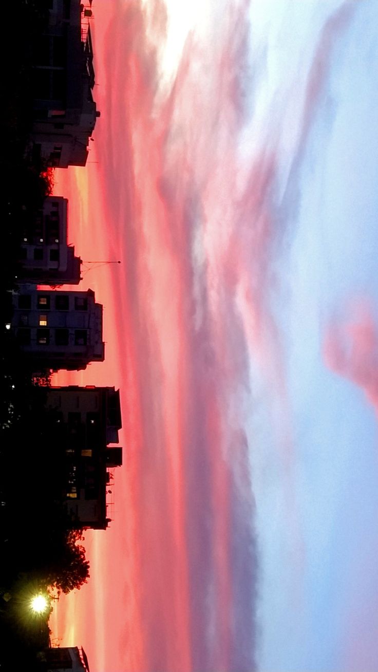 the sky is pink and blue with some clouds