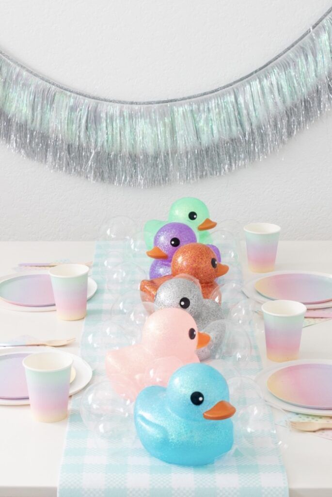 a table topped with plastic ducks and cups