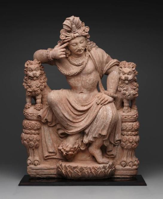 a statue of a woman sitting on top of a chair with her hands in her hair