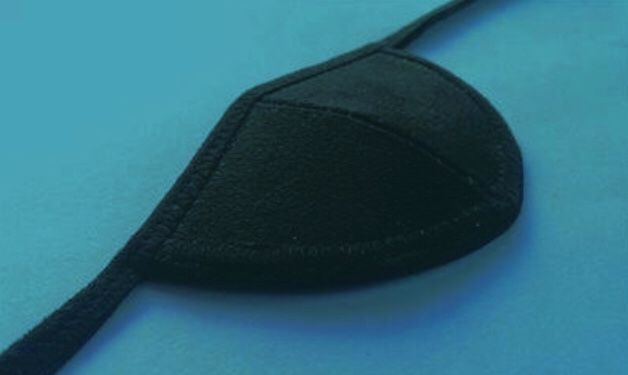 a close up of a black object on a blue surface with a cord attached to it