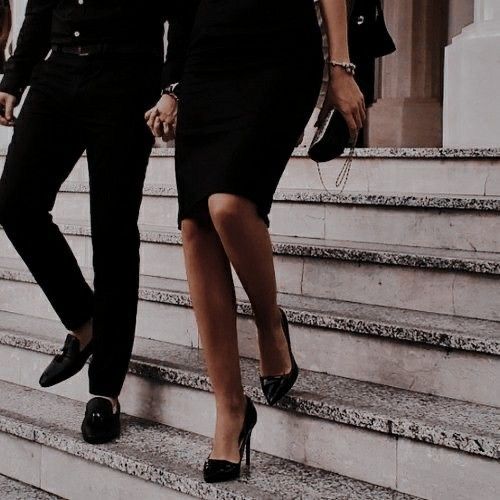 two women walking down some steps with one holding the hand of another woman's shoulder