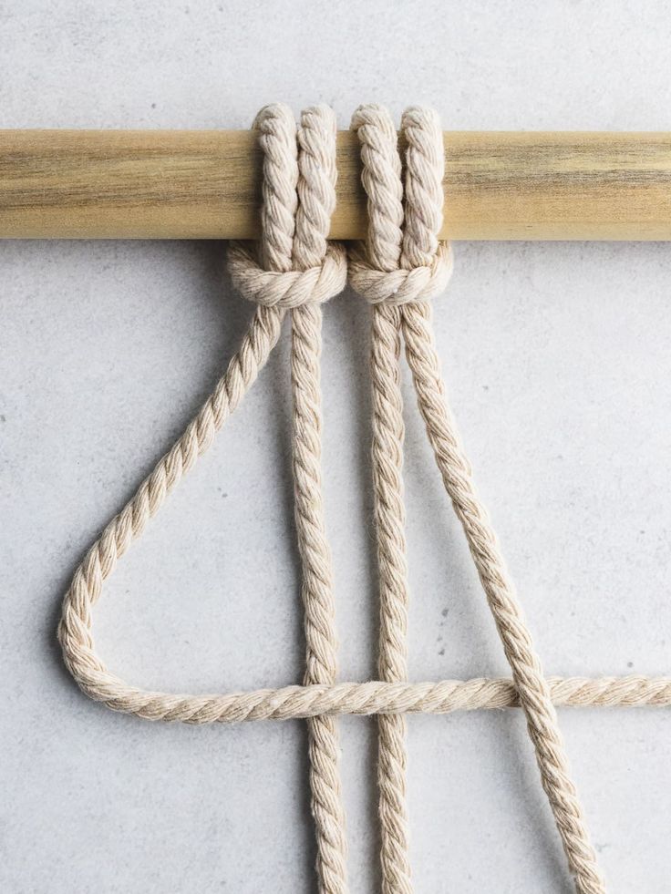 the rope is tied up and ready to be used as a wall hanging or door hanger