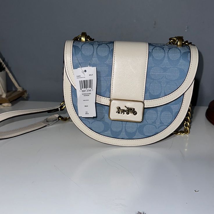 Coach Brand New Light Blue And White. Designer Blue Satchel Shoulder Bag, Designer Light Blue Shoulder Bag With Detachable Strap, Designer Light Blue Bag With Detachable Strap, Light Blue Top Handle Shoulder Bag With Gold-tone Hardware, Designer Light Blue Bags With Detachable Strap, Blue Crossbody Bag With Dust Bag Included, Blue Designer Satchel Shoulder Bag With Dust Bag, Blue Designer Satchel With Dust Bag, Designer Blue Satchel With Adjustable Strap