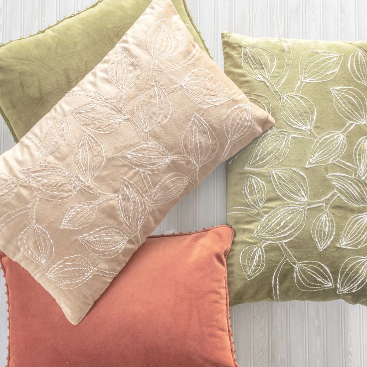 four pillows with different colors and designs on them