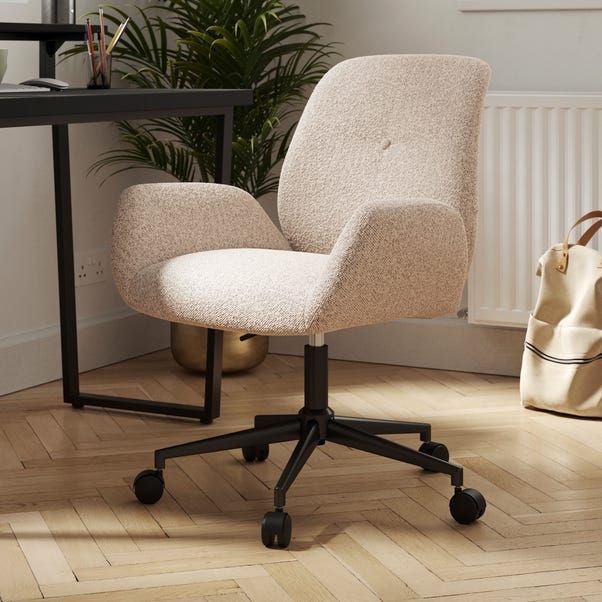 an office chair sitting on top of a hard wood floor next to a table with a bag