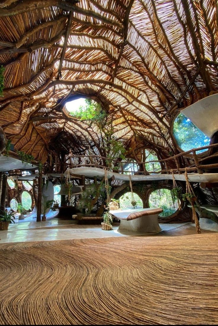 the inside of a building with lots of trees and plants on it's roof