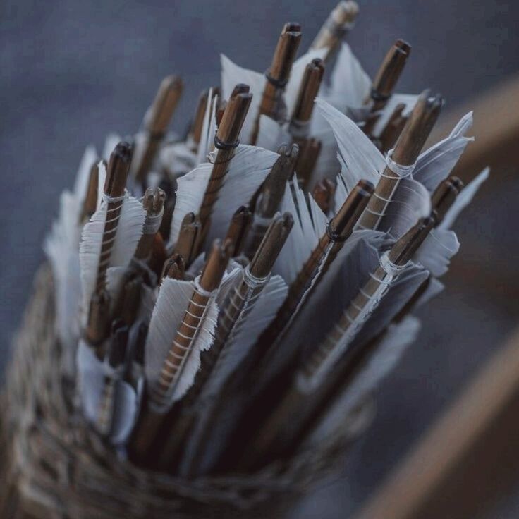 a basket filled with lots of umbrellas on top of a table