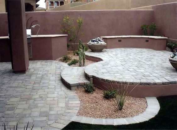 an outdoor patio with stone steps and planters