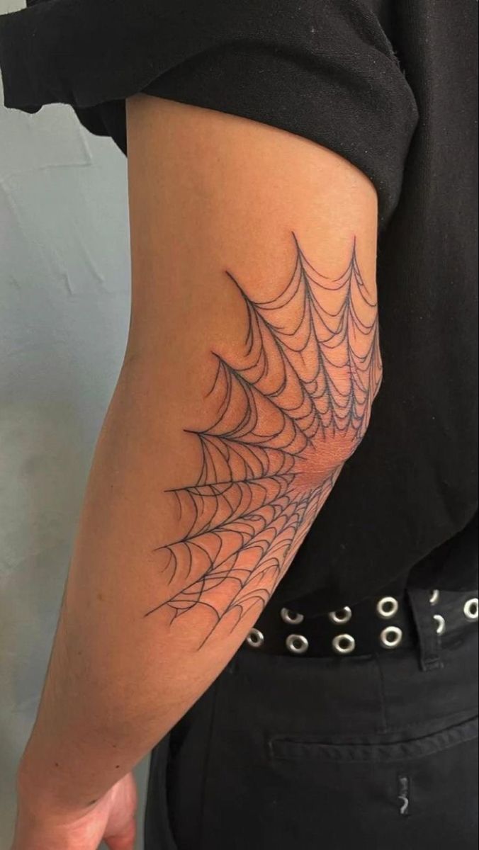 a person with a spider web tattoo on their arm