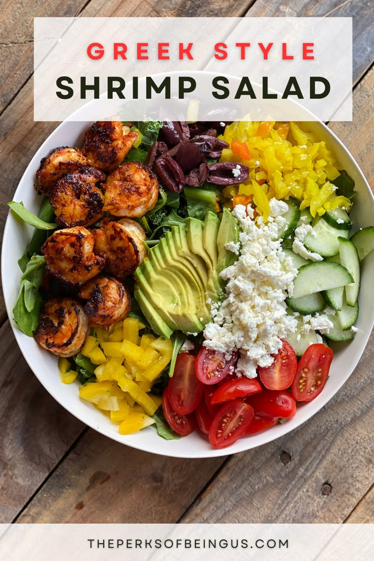 a bowl filled with shrimp, avocado, tomatoes and other vegetables on top of a wooden table