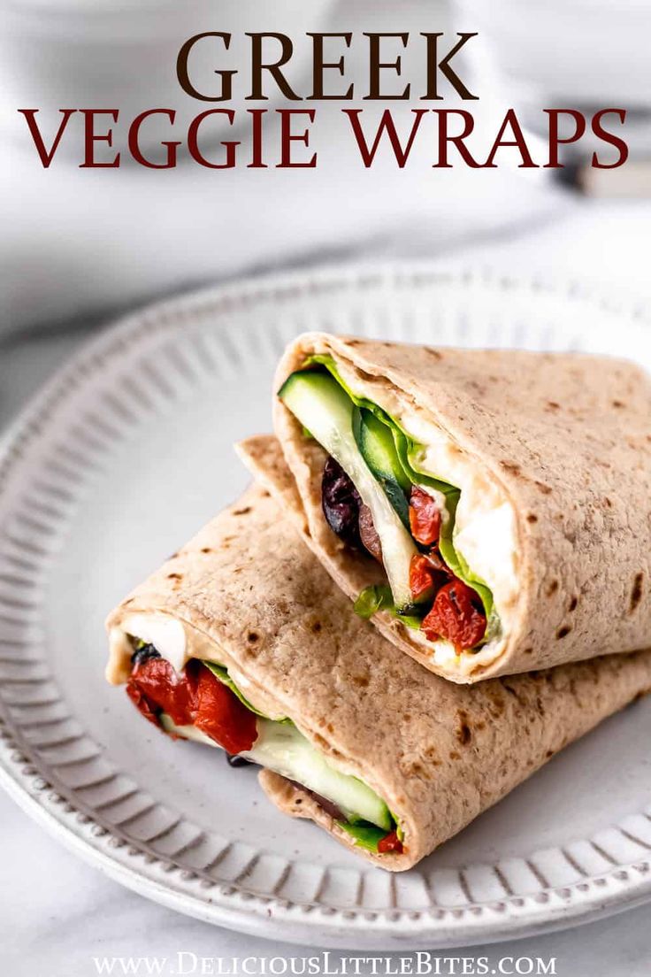 greek veggie wraps on a white plate with the title text overlay reads, greek veggie wraps