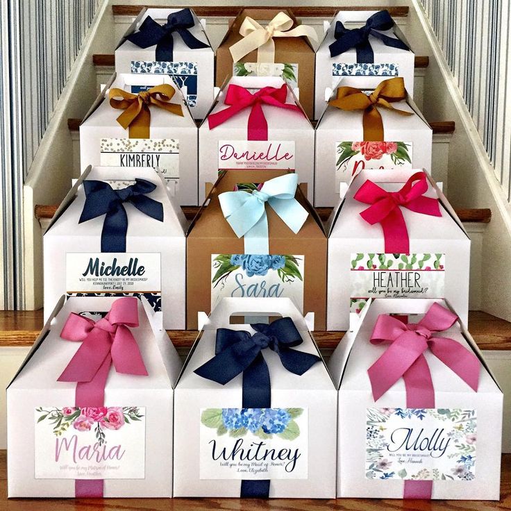 a bunch of boxes that are sitting on the stairs with ribbons and bows around them