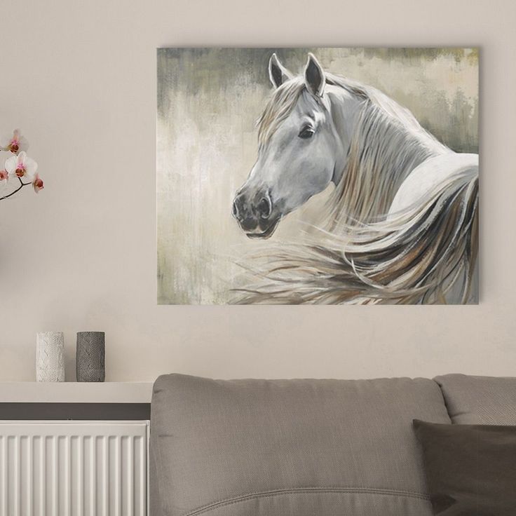 a painting of a white horse is hanging on the wall