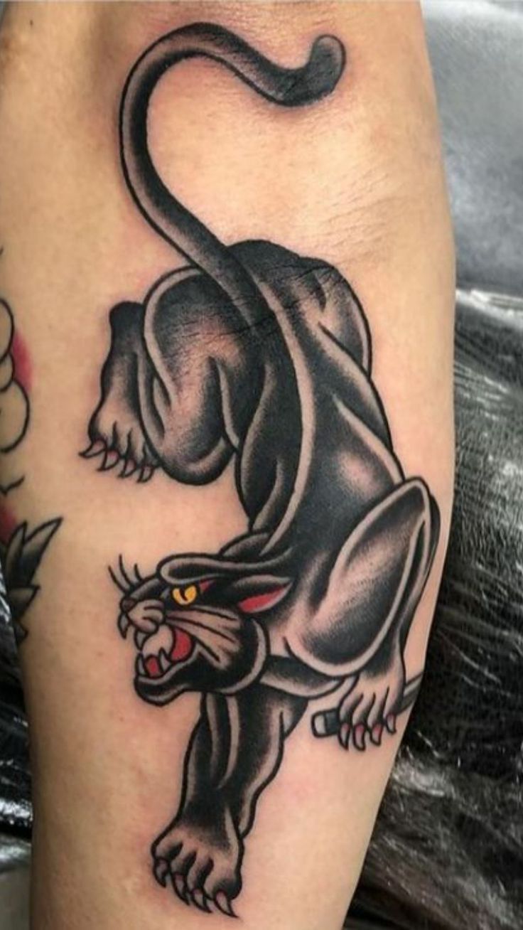 a black panther tattoo on the leg