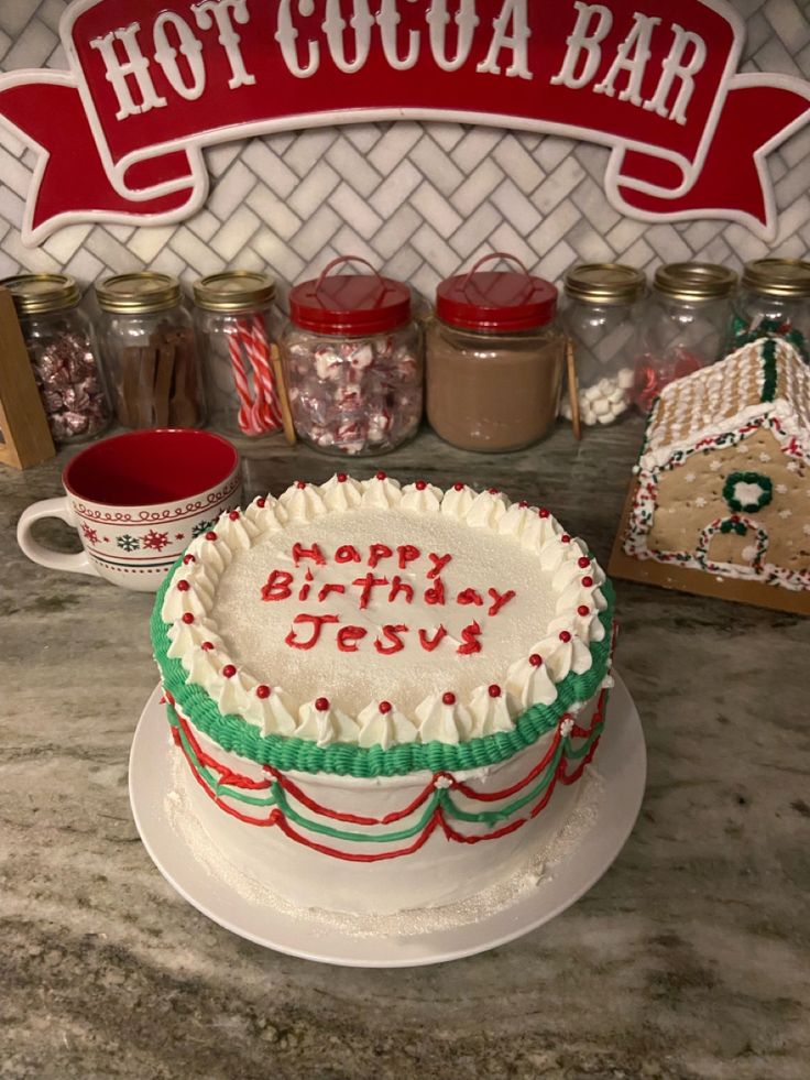 a birthday cake sitting on top of a counter next to some jars and peppermints