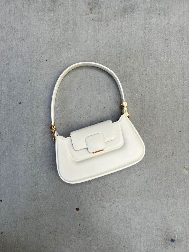 Versatile White Shoulder Bag With Gold-tone Hardware, Chic White Satchel With Top Carry Handle, Chic White Satchel With Adjustable Handle, Chic White Shoulder Bag With Adjustable Handle, Chic Double Handle Shoulder Bag With Fold Over Clasp, Chic Baguette Bag With Adjustable Handle, White Shoulder Bag With Fold Over Clasp For Evening, White Everyday Bag With Pearl Handle, Everyday White Bags With Pearl Handle