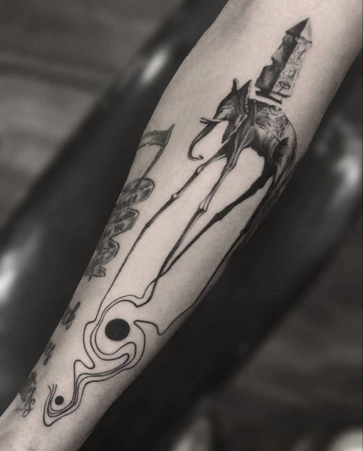 a black and white photo of a person with a horse tattoo on their arm