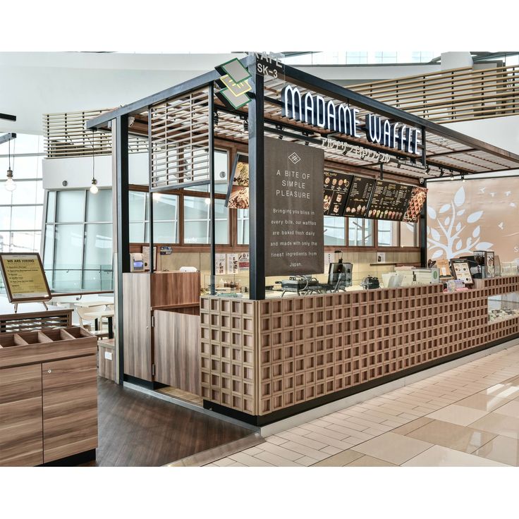 the inside of a restaurant with wooden tables and counter tops, along with an awning