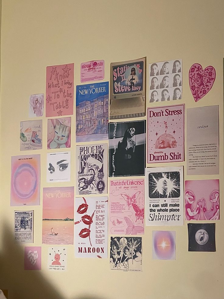 the wall is covered with many different posters and pictures, including heart shaped stickers