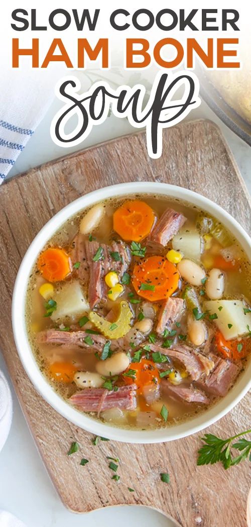 a bowl of slow cooker ham bone soup on a cutting board