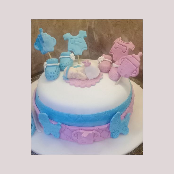 a baby shower cake with blue and pink icing