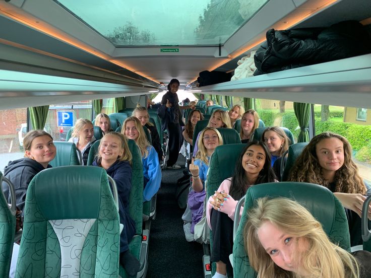 a group of people sitting on top of a bus