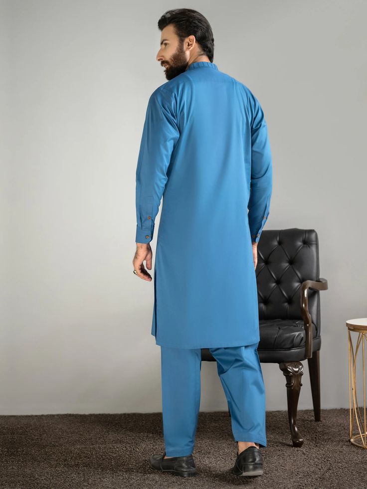 2 Piece Embroidered Cotton Suit (Kurta+Shalwar)Ban necklineGeometric pattern embroidery on the ban and placketWooden button closure on the placket and cuffsTwo side pocketsFull sleevesDyed shalwarColor: Teal BlueFabric (Kurta+Shalwar): CottonWeight: 460 gModel is wearing size "M"Code: P8918SK-XSS-TBL Care InstructionsWash light and bright colors separately. Do not bleach. Do not twist/wring, warm iron to sequined, beaded, and delicate fabrics. Do not dry in direct sunlight.DisclaimerActual color Long Sleeve Cotton Salwar Kameez With Naqshi, Long Sleeve Cambric Kurta With Naqshi, Fitted Cotton Lawn Suit For Work, Cotton Sets For Workwear And Eid, Festive Cotton Lawn Suit For Workwear, Traditional Cotton Lawn Suit For Work, Cotton Kurta For Work And Eid, Long Sleeve Lawn Suit For Eid Workwear, Traditional Long Sleeve Lawn Suit For Work