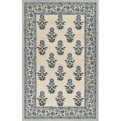 a white rug with blue flowers on it