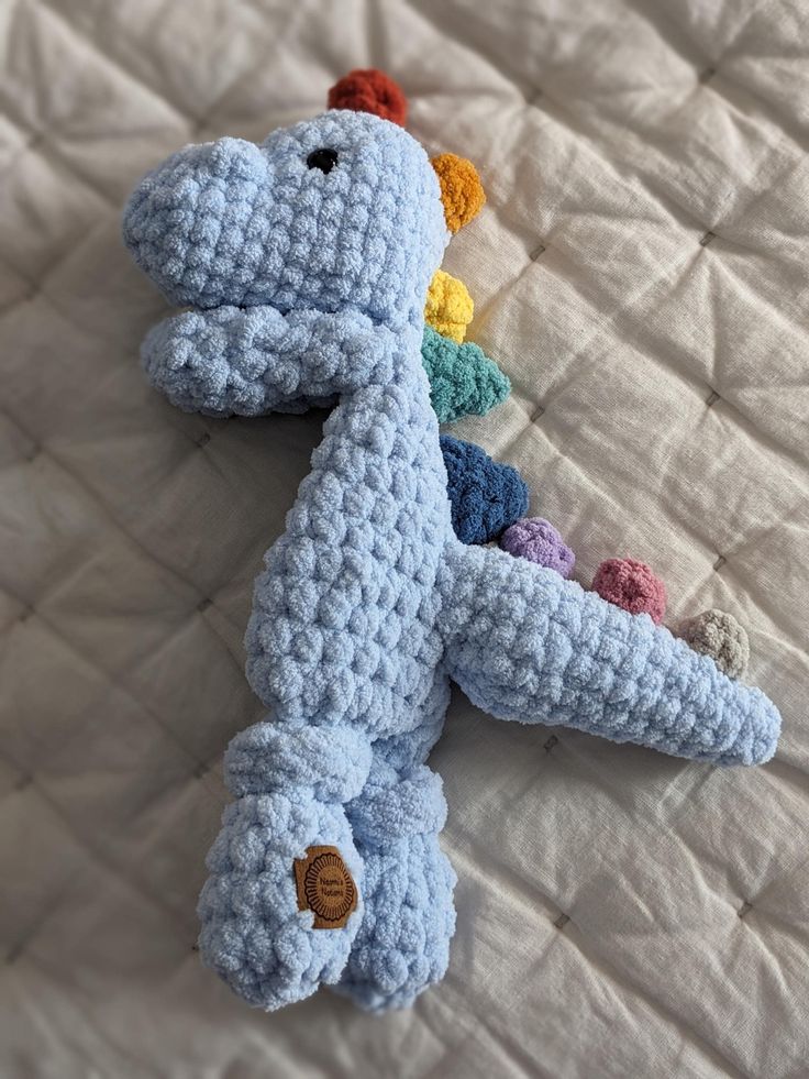 a crocheted toy laying on top of a bed