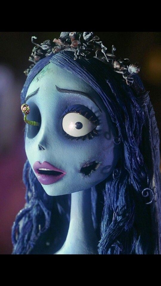 a creepy doll with blue hair and makeup