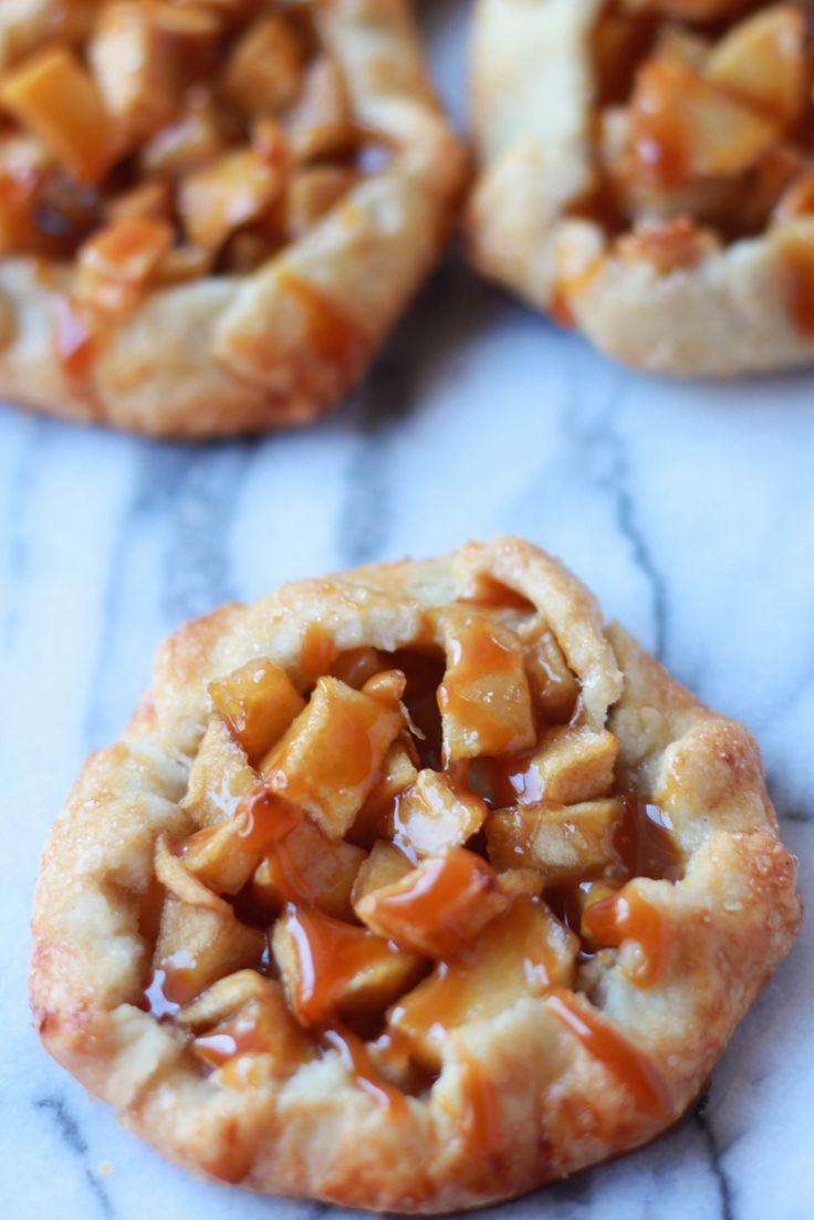 apple pies with caramel filling on a marble surface