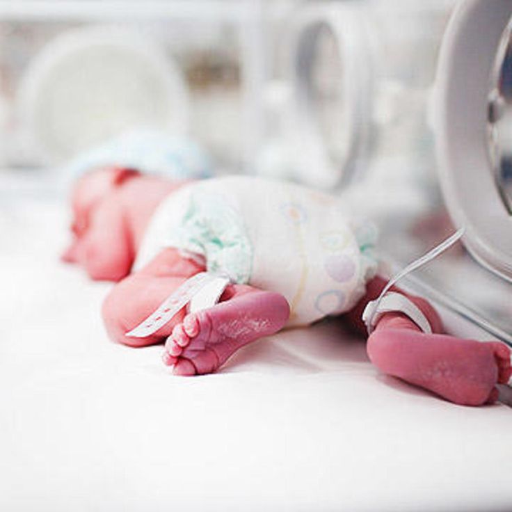 a baby doll is laying on the floor in front of a dryer and mirror