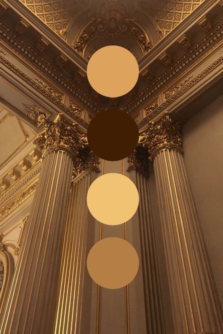 three circles are hanging from the ceiling in an ornate room with gold and white decor