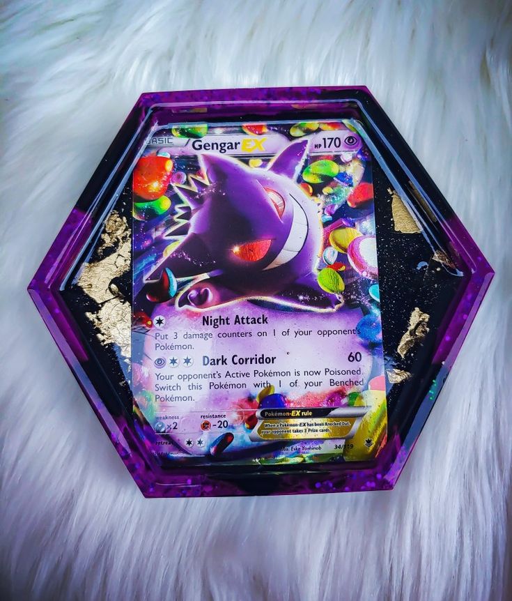 a close up of a purple and black pokemon card