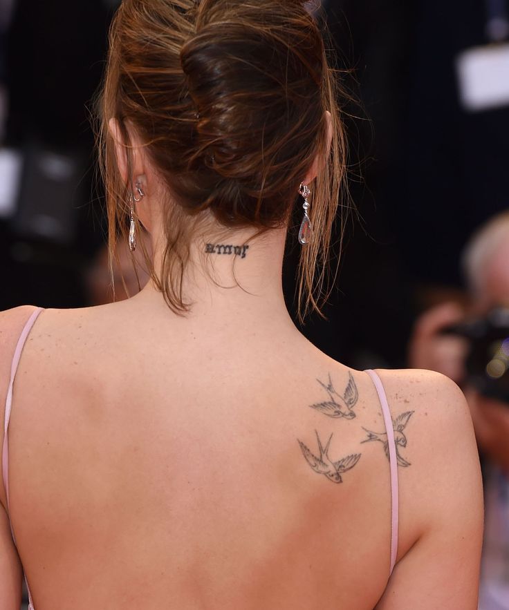 a woman with tattoos on her back