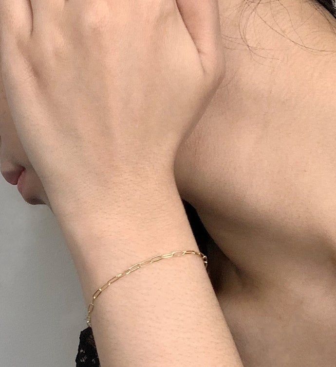 This delicate 14K gold filled chain bracelet is so light, you'll forget your wearing it. That is until you see it catch the light brilliantly. This is the perfect chain to wear with literally anything, and it the ideal "starter" piece for building up a stack. Simple, elegant and made in NYC by Herself Collections. | This delicate 14K gold filled chain bracelet is so light, you'll forget your wearing it. That is until you see it catch the light brilliantly. This is the perfect chain to wear with Dainty 14k Gold Filled Adjustable Chain Bracelet, Dainty Adjustable 14k Gold Paperclip Bracelet, Dainty Everyday Chain Bracelet, Dainty Gold Bracelet With Adjustable Chain For Everyday, Delicate 14k Gold Filled Bracelets For Everyday, Dainty Gold Charm Bracelet With Adjustable Chain, Dainty 14k Gold Filled Chain Bracelet As A Gift, Dainty Everyday Gold Bracelet With Adjustable Chain, Dainty 14k Gold Filled Chain Bracelet For Gift