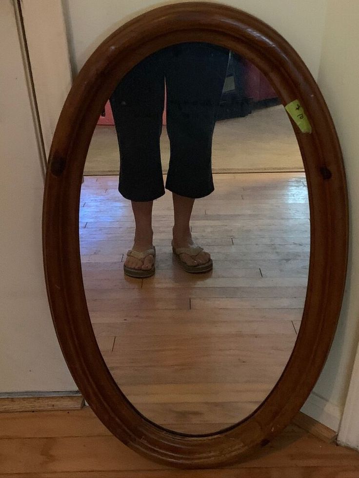 a person standing in front of a mirror on the floor