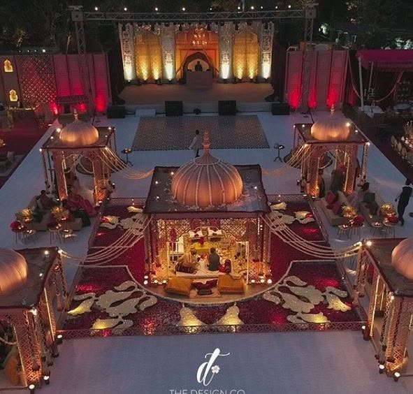 an aerial view of a wedding venue with lights and decorations on the floor, decorated in gold and red