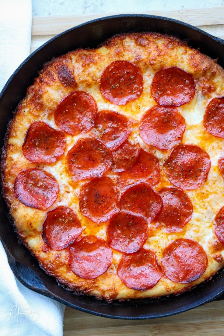 a pepperoni pizza in a cast iron skillet