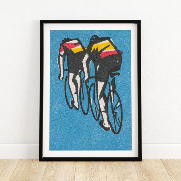 a painting of two people riding bikes on a blue background in a black frame against a white wall