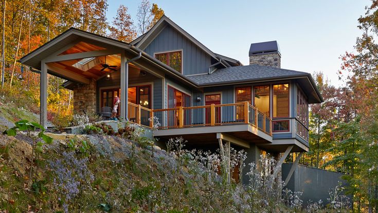 a large house sitting on top of a lush green hillside