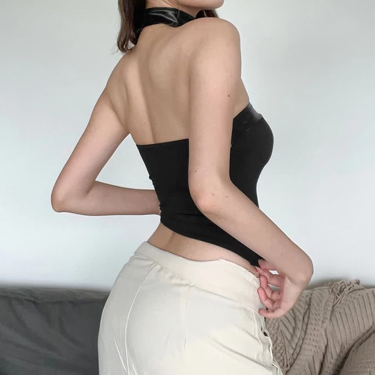 Indulge in luxury and sophistication with our Black Asymmetrical Hem Open Shoulder Tube Top. This crop top features an alluring asymmetrical hem and open back design for a strikingly elegant look. The sleek PU leather hem adds an edgy touch, while the included choker completes the exclusive all-black ensemble. Elevate your style and make a bold statement with this must-have piece. Asymmetrical hem for a unique silhouette Open back design for an elegant touch Sleek PU leather hem for an edgy look Crop length for a bold statement Includes a matching choker for a complete look Party Crop Top With Built-in Bra And High Stretch, Elegant Club Crop Top With Built-in Bra, Chic Backless Top For Date Night, Fitted Backless Top For Date Night, Edgy Party Tops With Built-in Bra, Halter Neck Crop Top For Club, Chic Backless Crop Top For Party, Sleek Halter Neck Top For Night Out, Sleek Party Crop Top