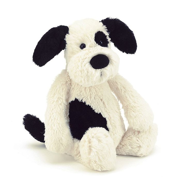 a black and white dog stuffed animal on a white background