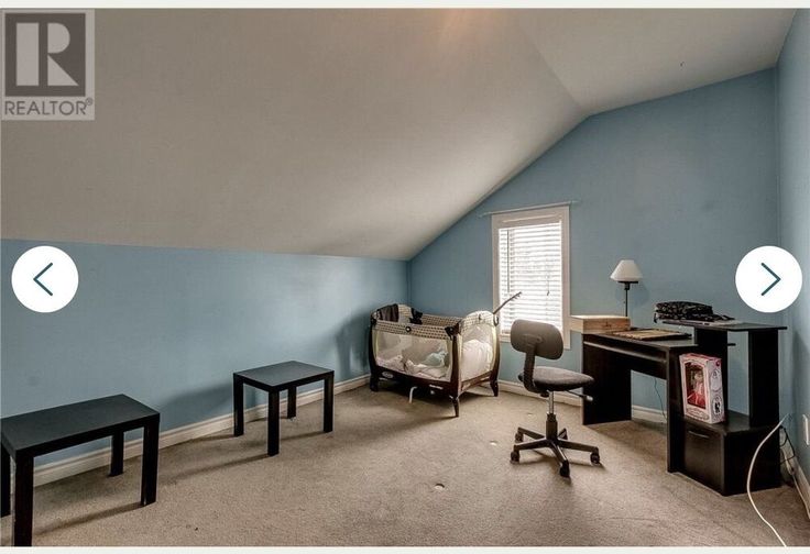 a room with blue walls and furniture in it