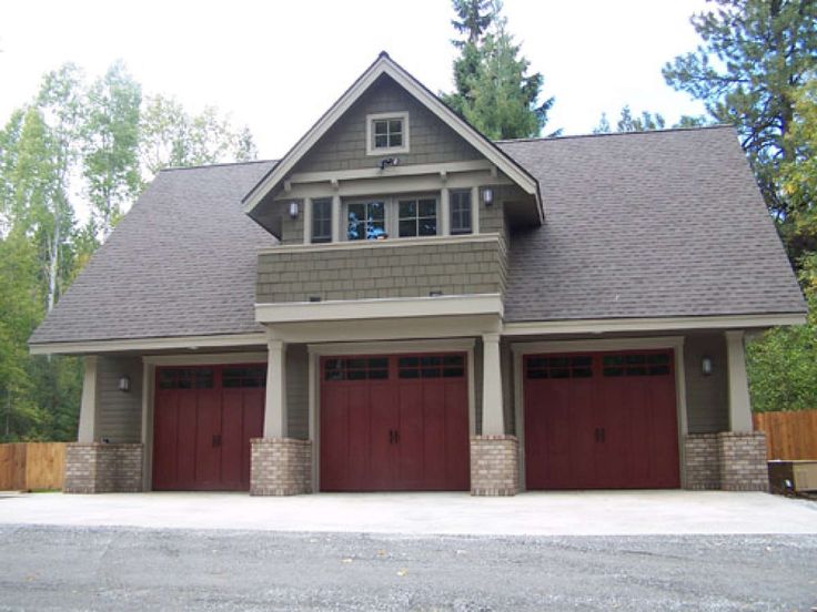 a two story house with three garages in the driveway